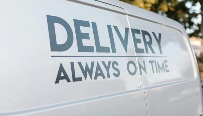 Close-up of delivery van with slogan 'Always On Time' emphasizing timely service.